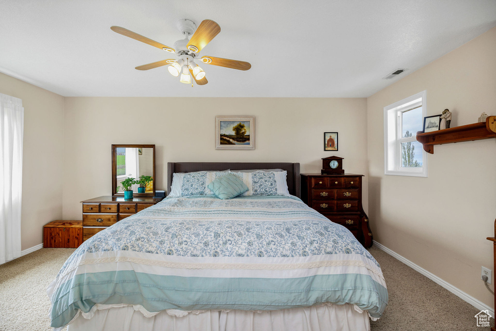 Bedroom with carpet floors, baseboards, and ceiling fan