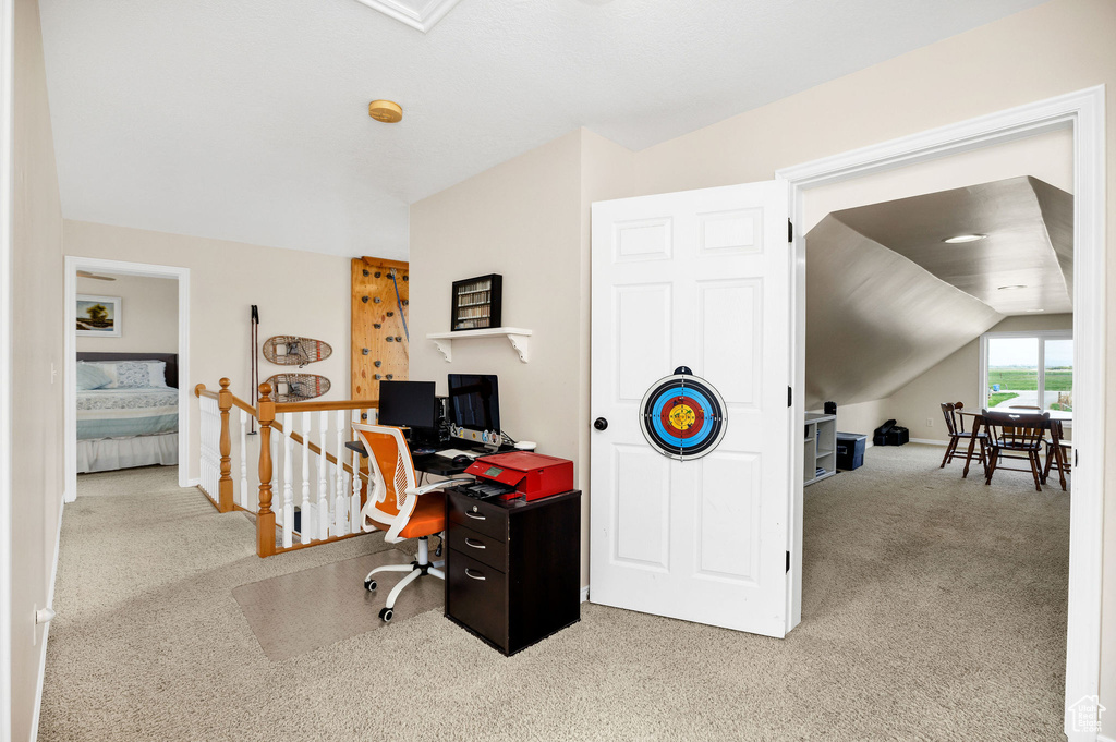 Office with carpet floors, lofted ceiling, and baseboards