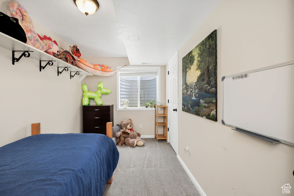 Carpeted bedroom featuring baseboards