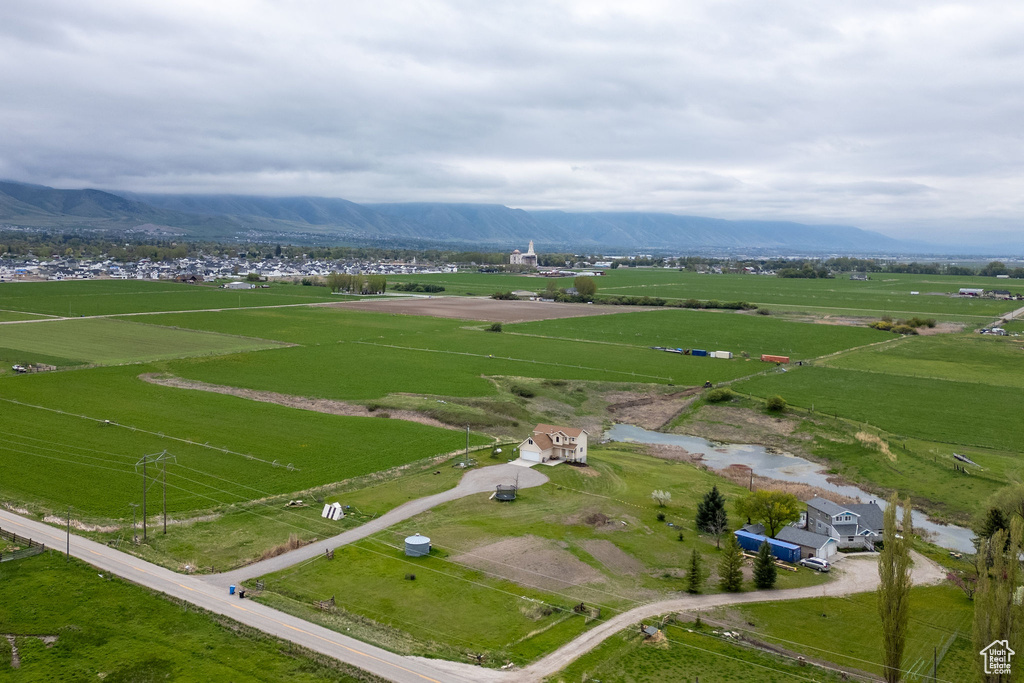 Aerial overview of property's location featuring rural landscape and a mountainous background