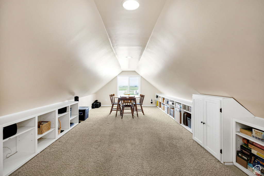 Bonus room featuring carpet floors and vaulted ceiling