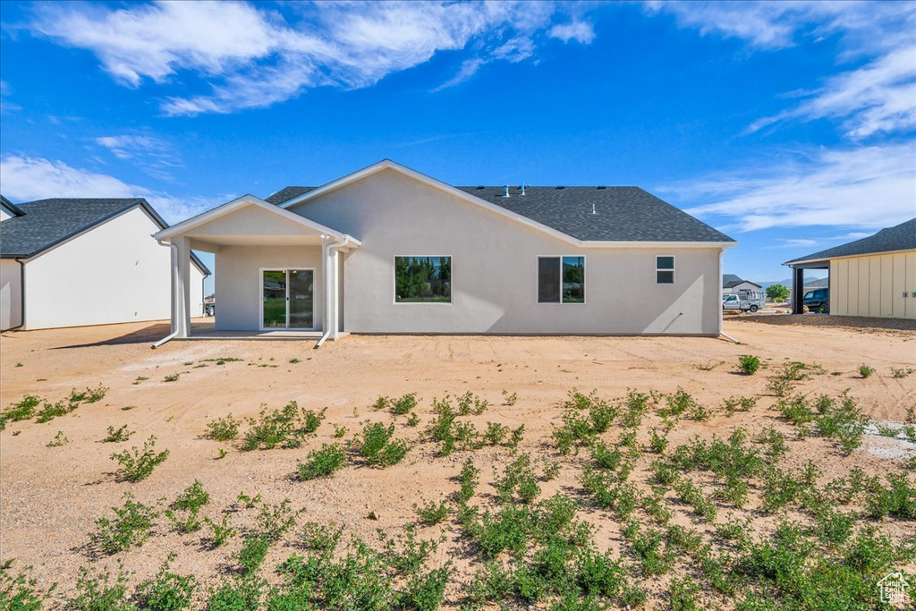 Rear view of property with stucco siding