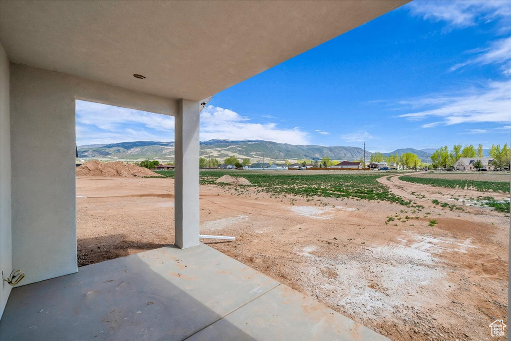 View of yard featuring a mountain view and a patio
