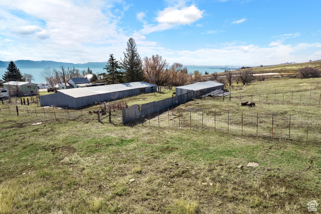 View of yard with an outbuilding, an outdoor structure, and fence
