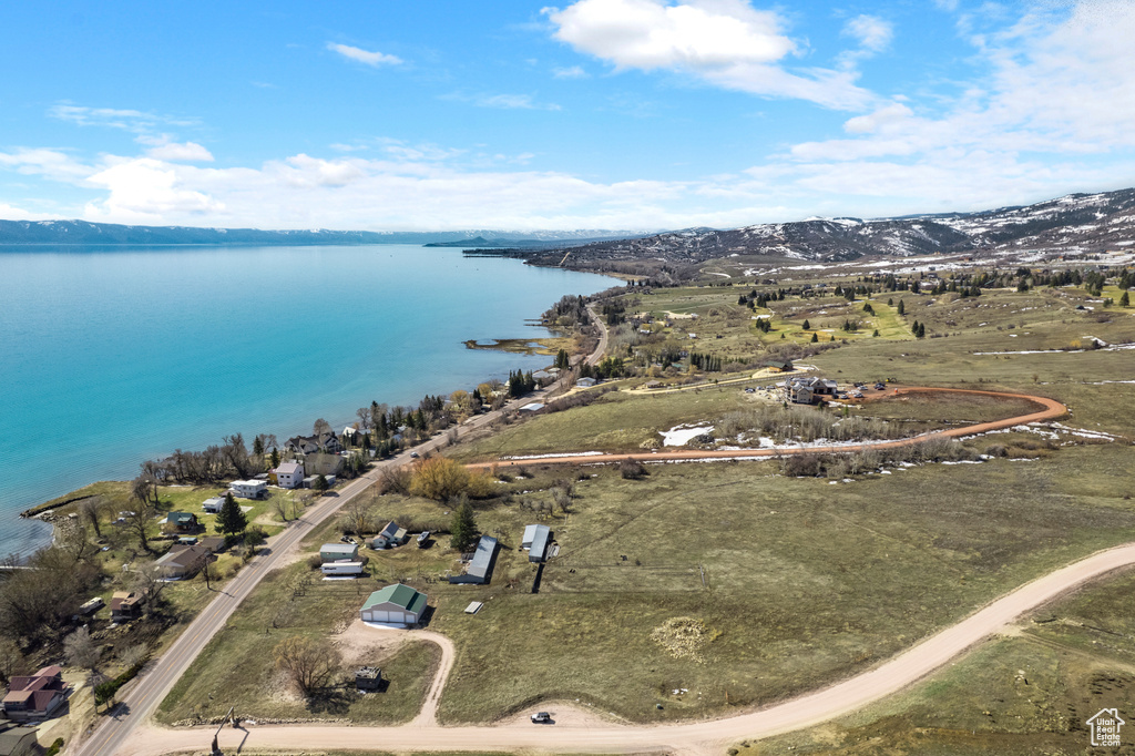 Birds eye view of property with a water and mountain view