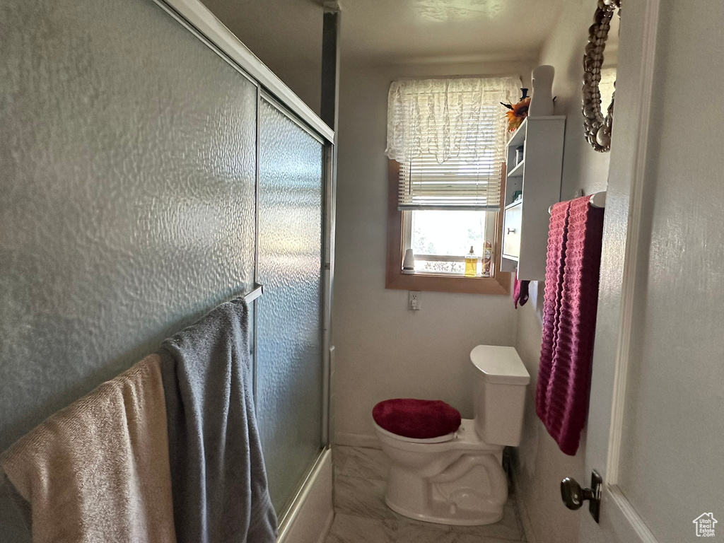 Bathroom with toilet and baseboards