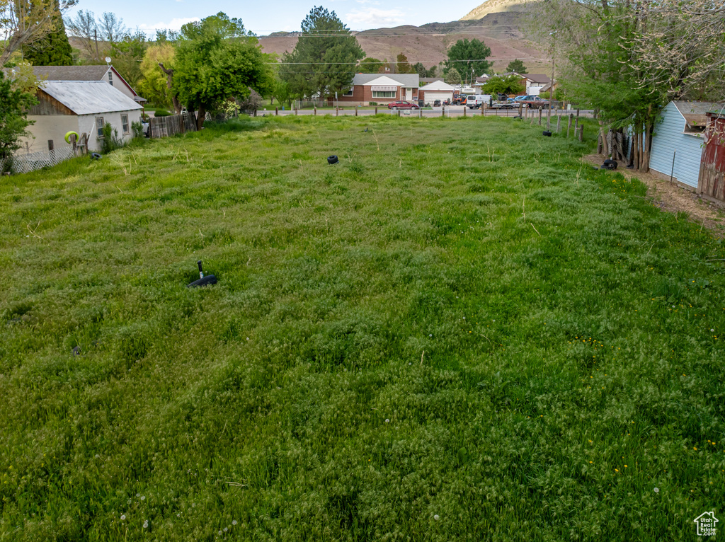 View of yard with fence and a mountain view