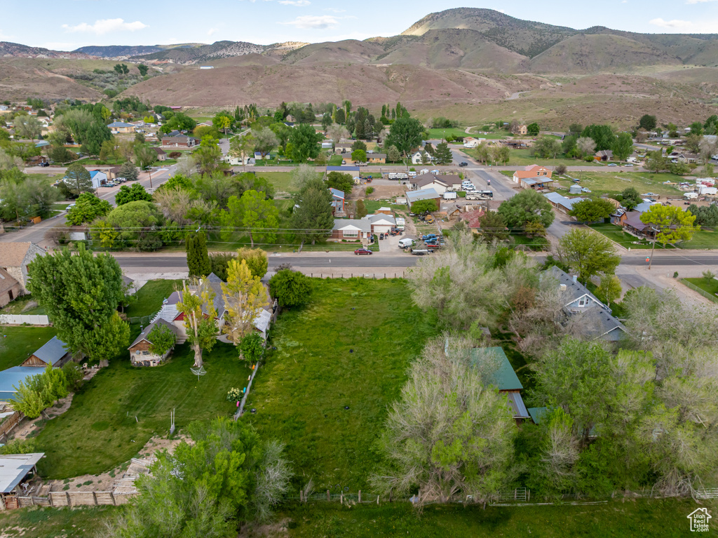 Aerial overview of property's location featuring nearby suburban area and mountains