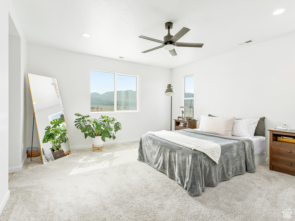 Carpeted bedroom featuring baseboards, ceiling fan, and recessed lighting