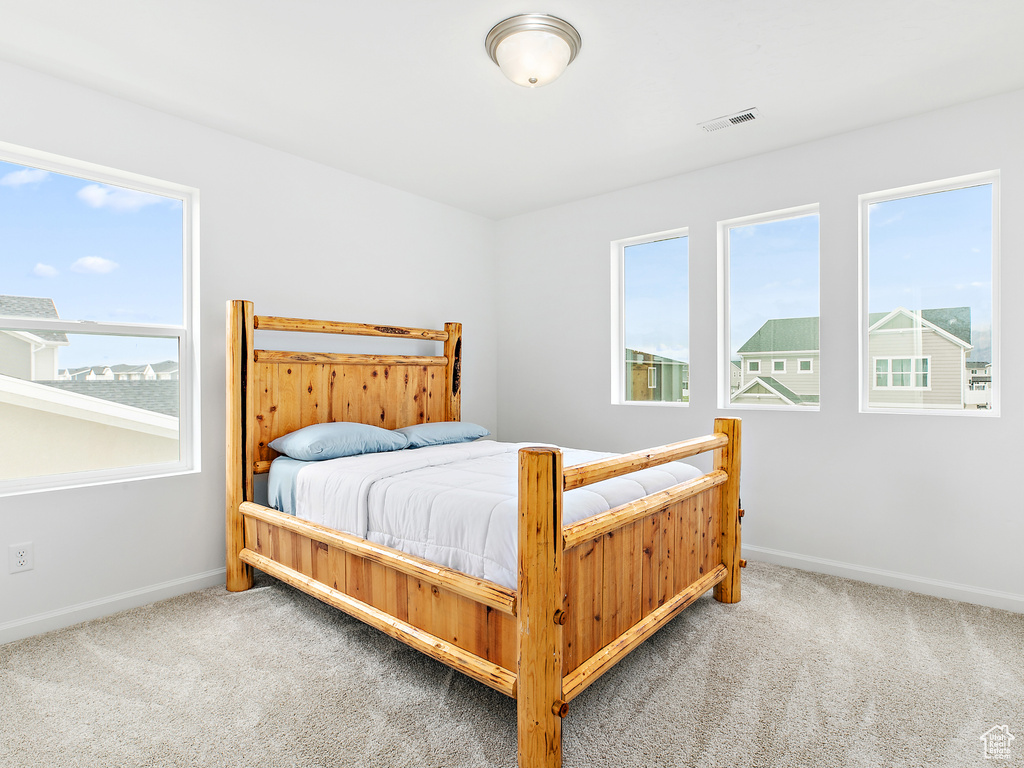 Bedroom featuring carpet flooring and baseboards
