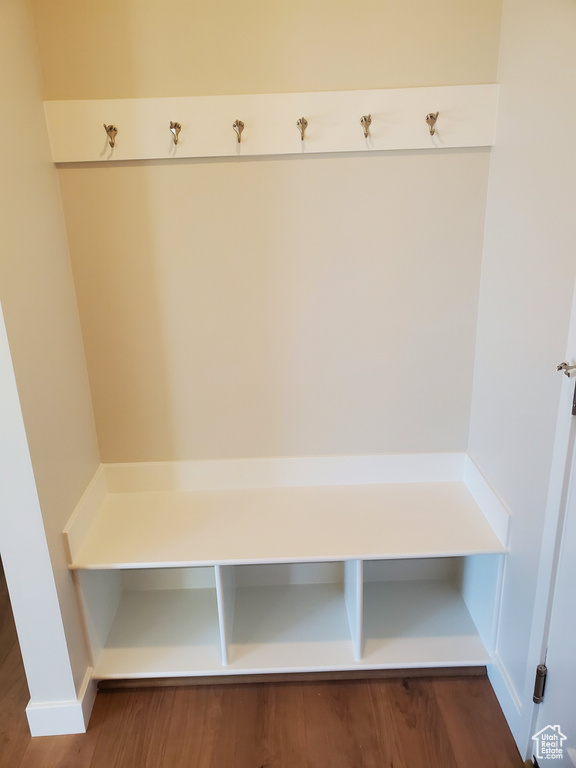 Mudroom featuring dark wood-style flooring and baseboards