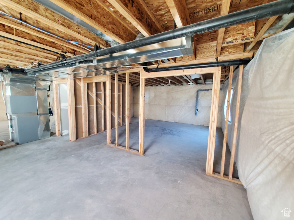 Unfinished basement featuring heating unit