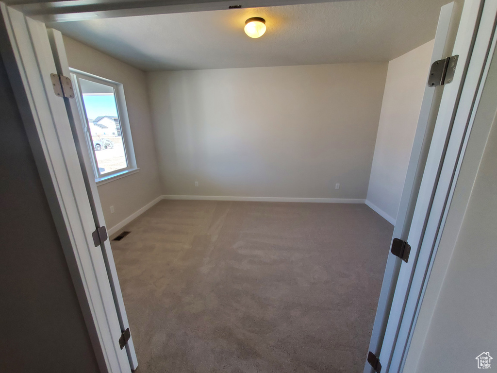 Unfurnished room featuring carpet flooring and baseboards