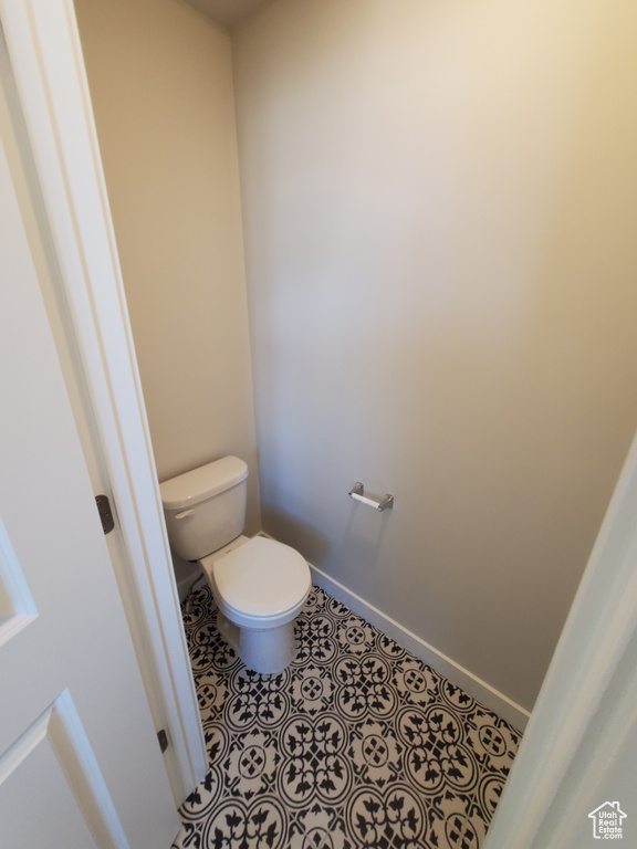 Bathroom featuring toilet and baseboards