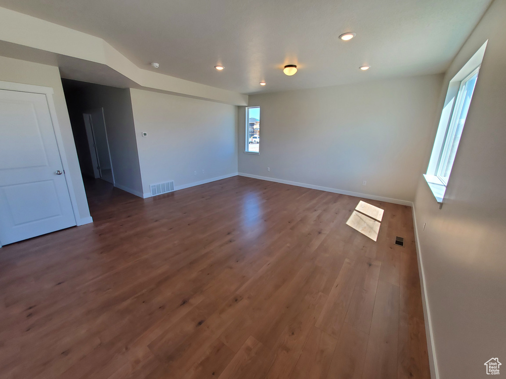 Unfurnished room featuring wood finished floors, recessed lighting, and baseboards
