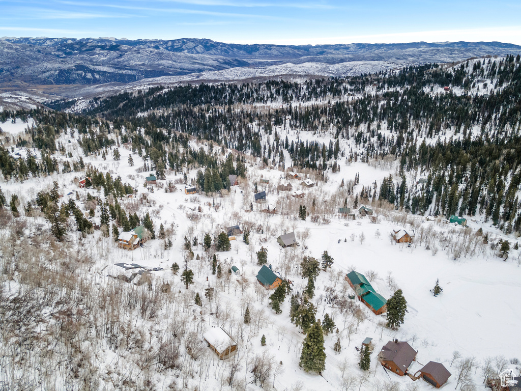 Snowy aerial view featuring a mountain view