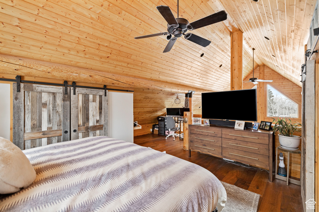 Bedroom with wood ceiling, lofted ceiling, dark wood-style floors, and a barn door