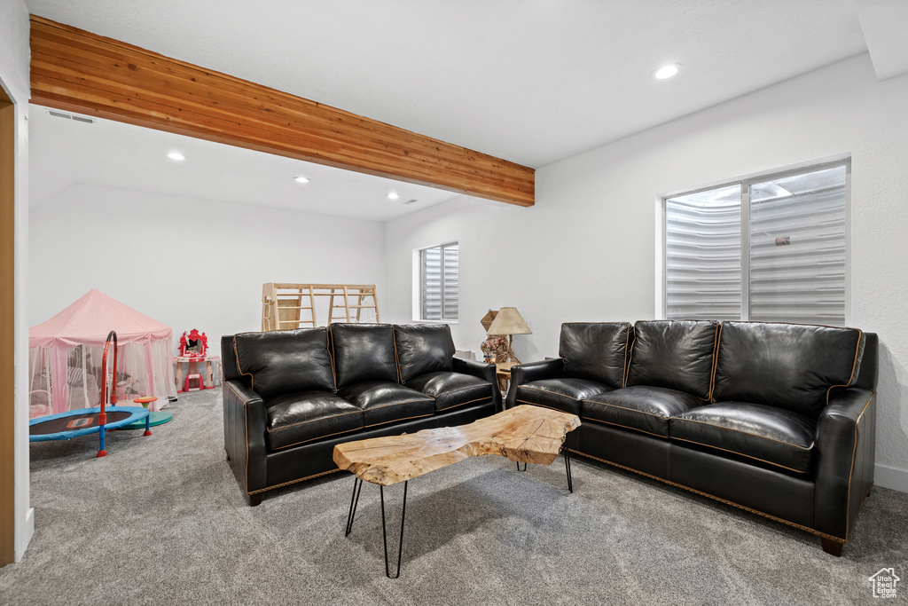 Carpeted living area with recessed lighting and beamed ceiling