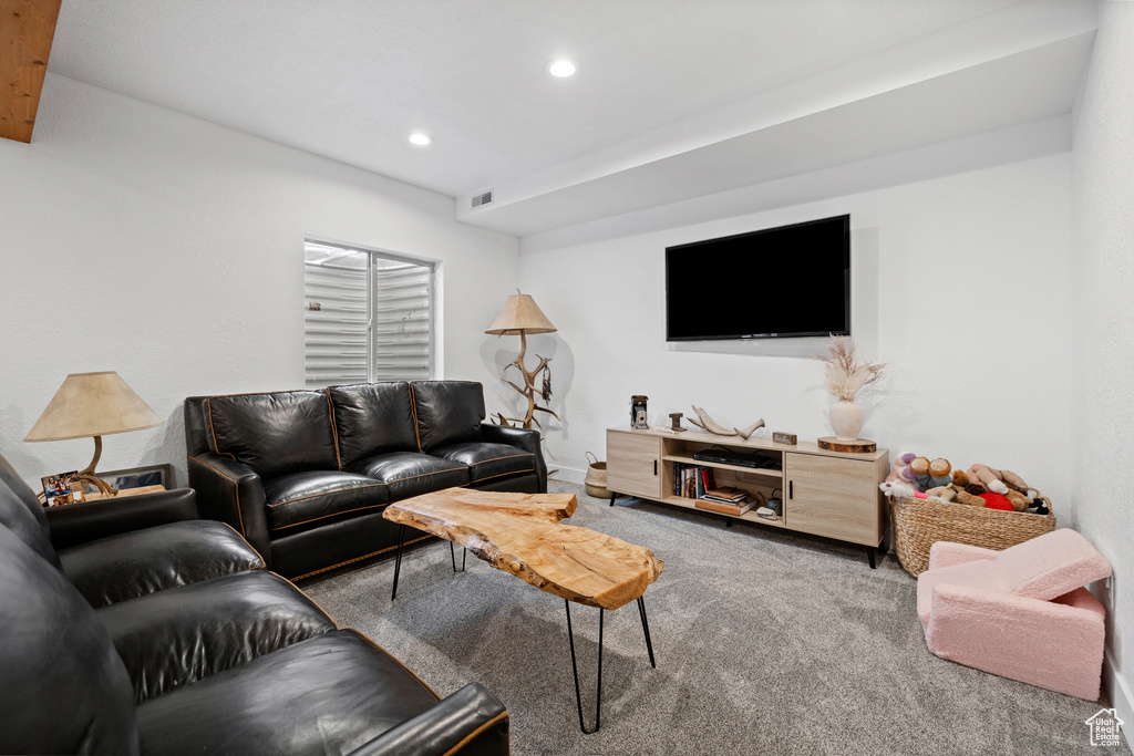 Living area with carpet and recessed lighting