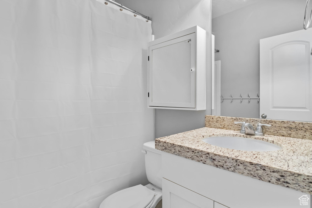 Full bath featuring toilet and vanity