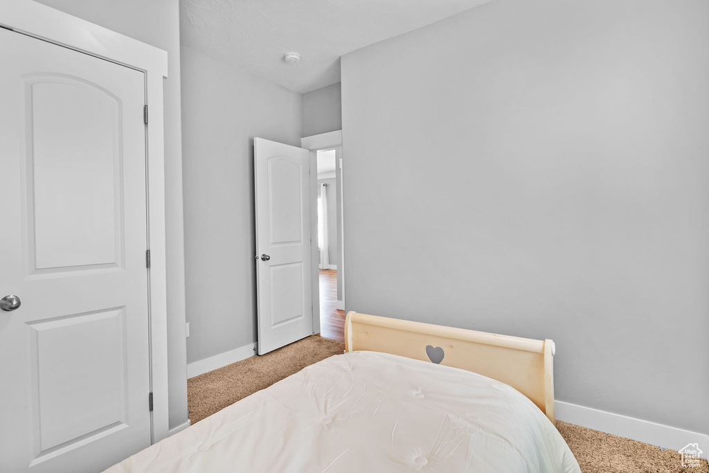 Carpeted bedroom with baseboards