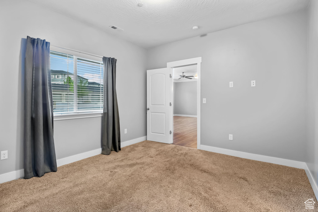 Unfurnished bedroom featuring baseboards, visible vents, and carpet floors