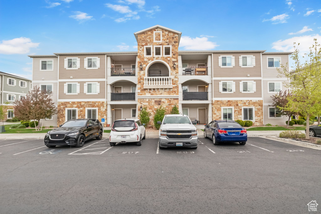 View of property with uncovered parking