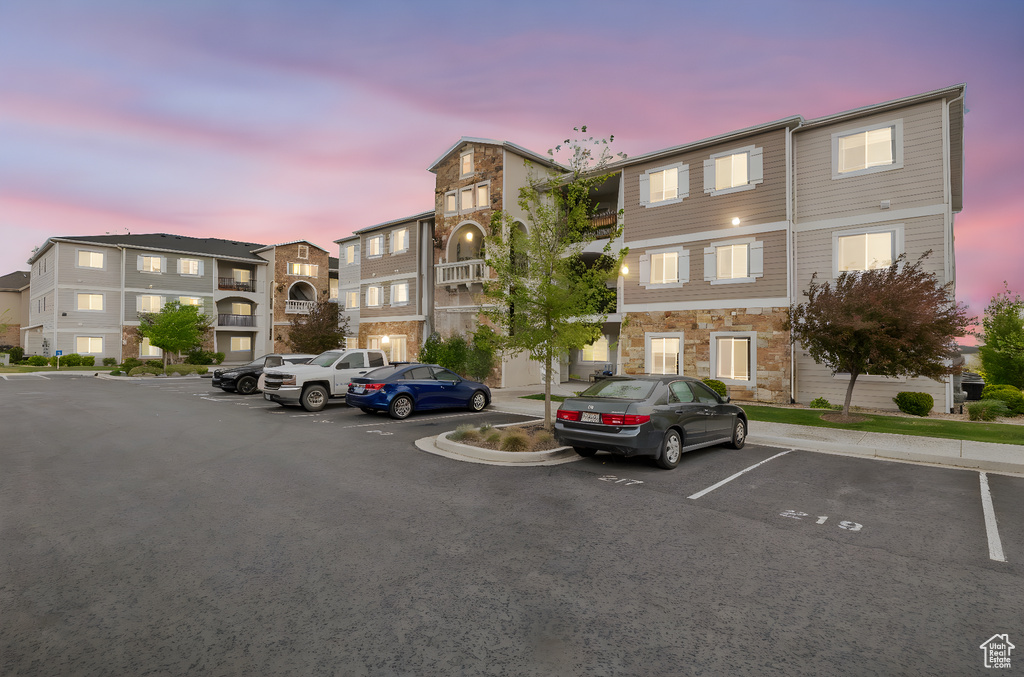 View of building exterior with uncovered parking