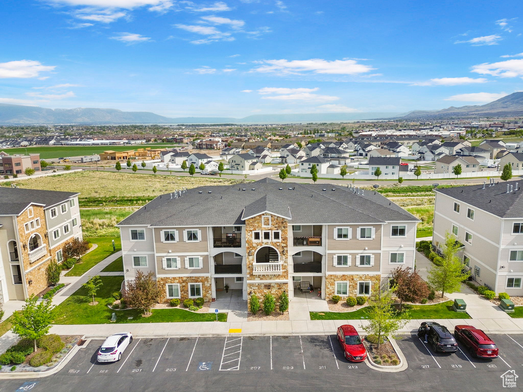 View of property featuring uncovered parking, a mountain view, and a residential view