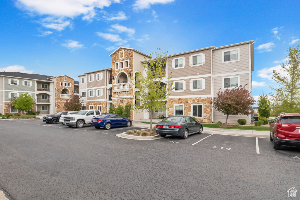 View of property featuring a residential view and uncovered parking