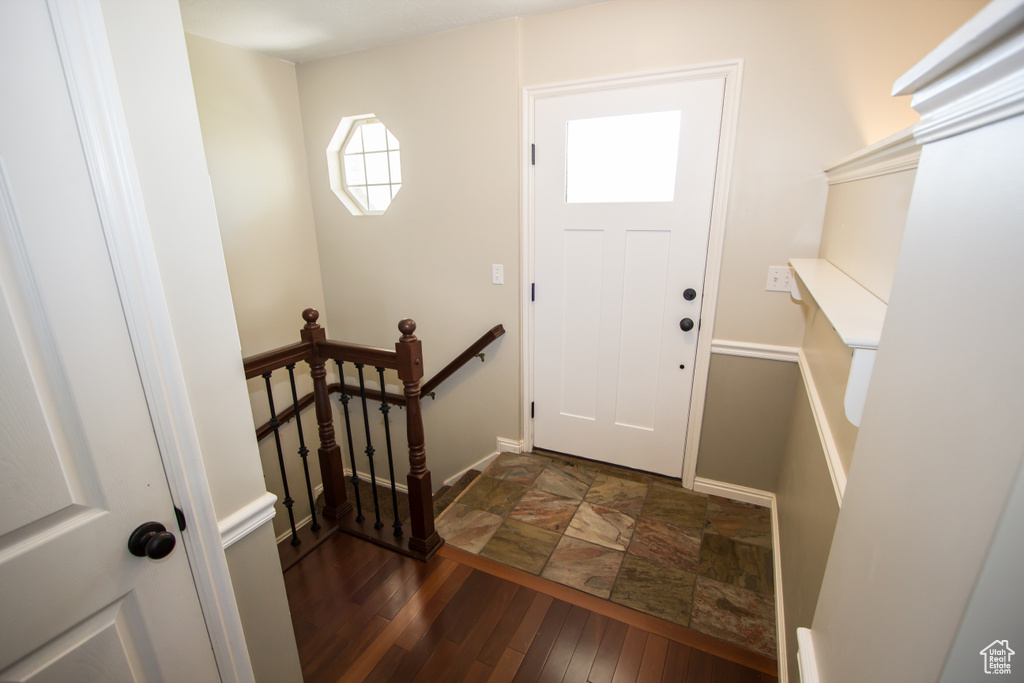Foyer featuring baseboards and stone finish floor