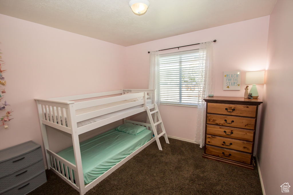 Carpeted bedroom featuring baseboards