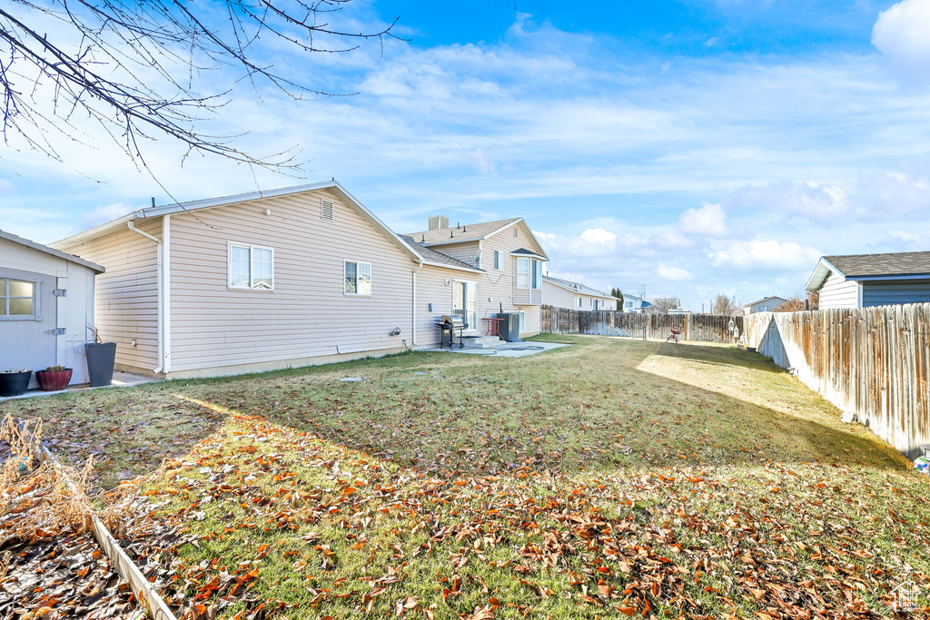 Back of house with cooling unit and a patio