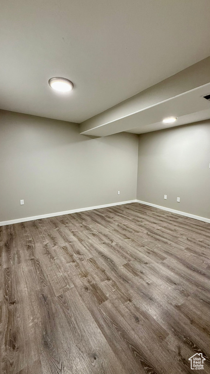 Finished below grade area with wood finished floors and baseboards