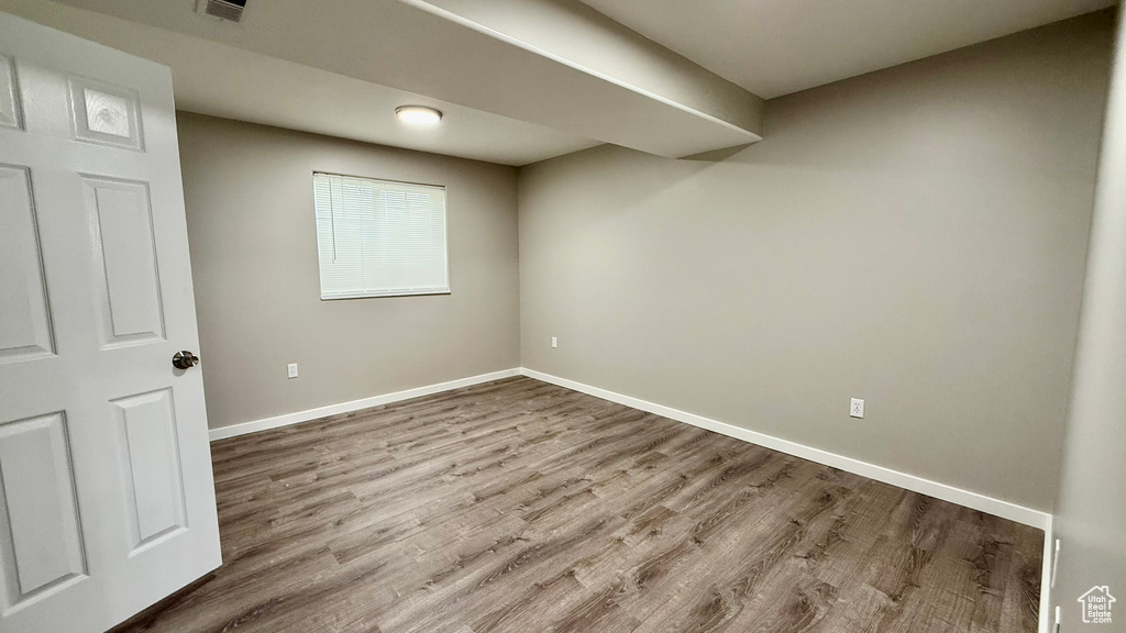 Below grade area featuring wood finished floors and baseboards
