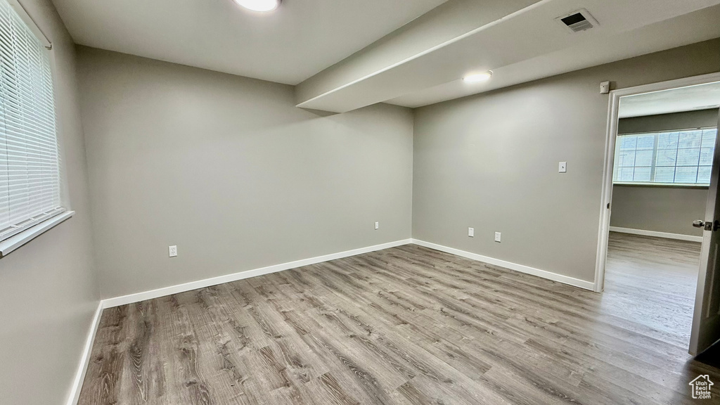 Unfurnished room featuring wood finished floors and baseboards