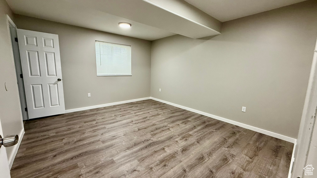 Unfurnished bedroom with wood finished floors and baseboards