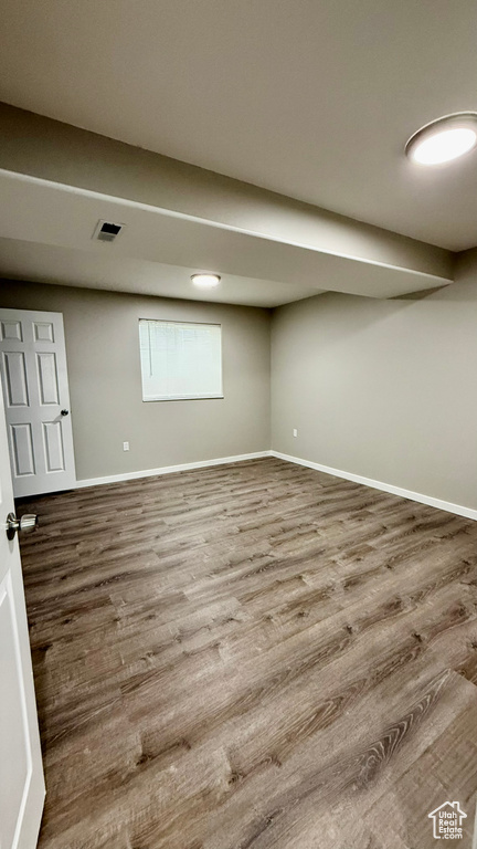Basement with wood finished floors and baseboards