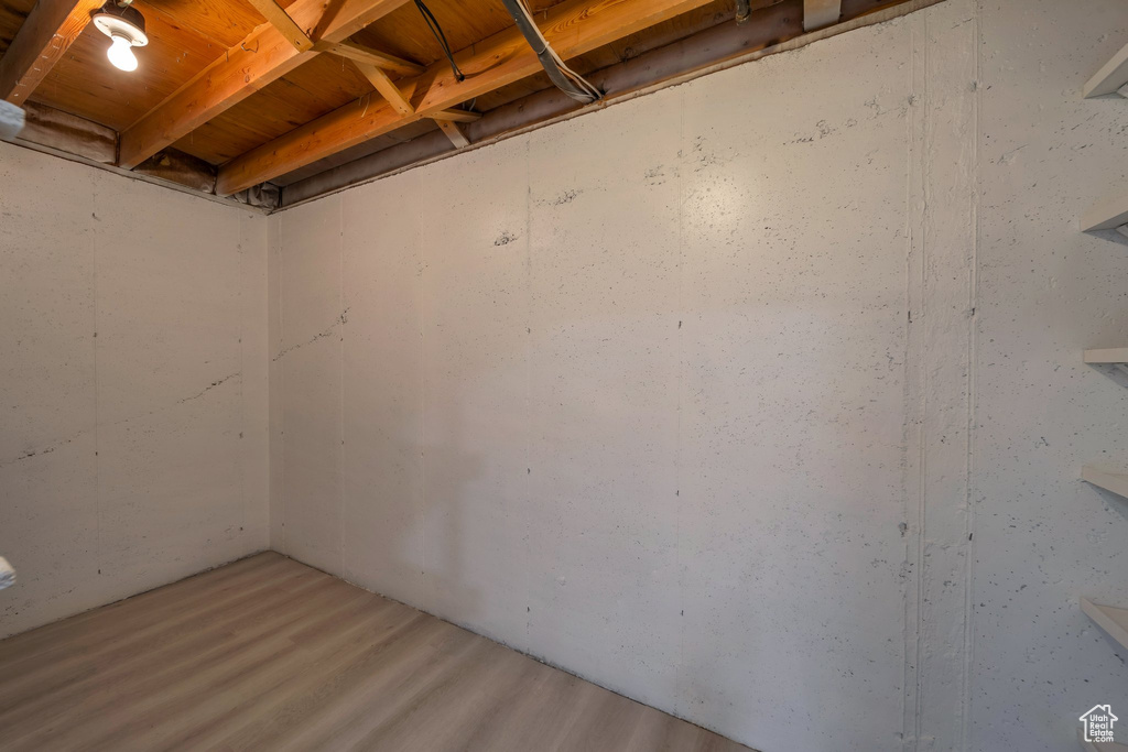 Unfinished basement featuring wood finished floors