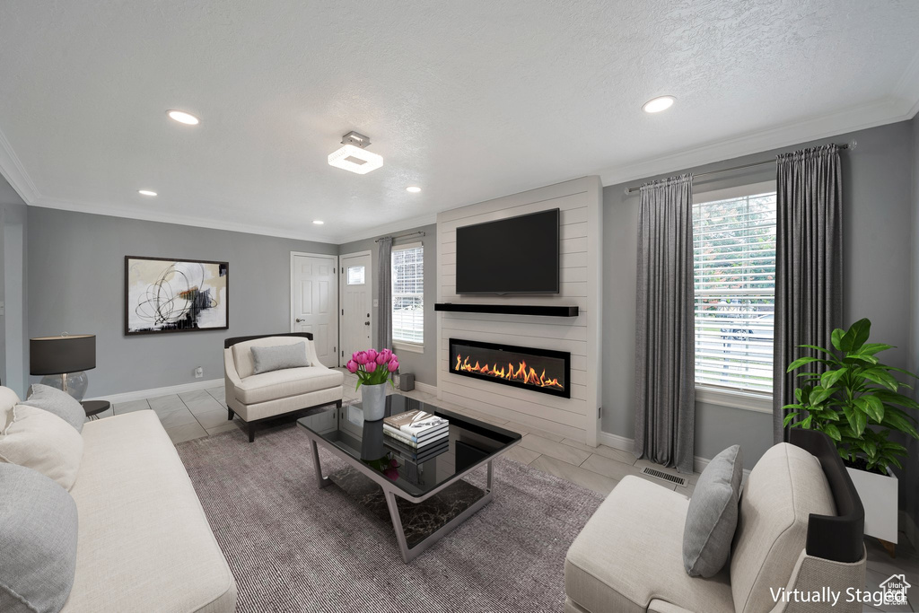 Tiled living room with recessed lighting, a large fireplace, crown molding, baseboards, and a textured ceiling
