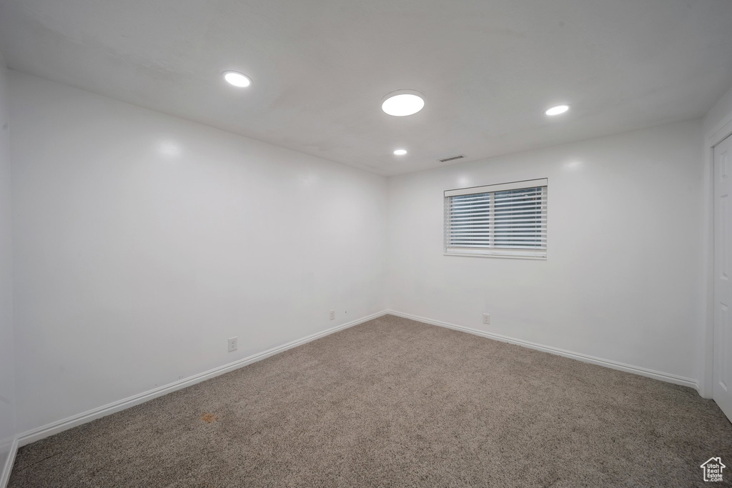 Spare room with carpet flooring, baseboards, and recessed lighting