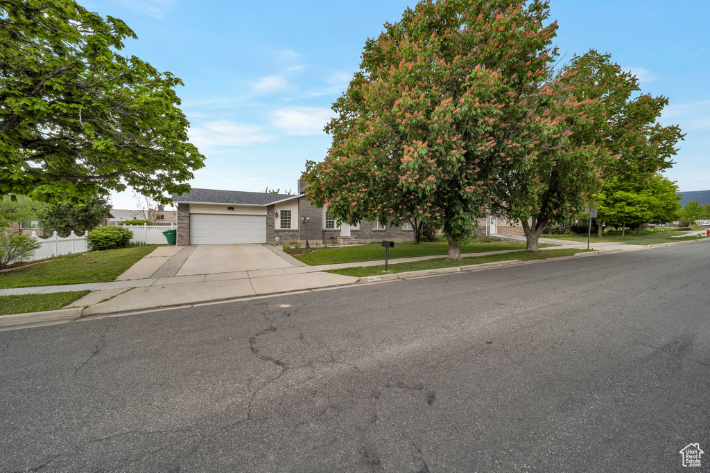 Obstructed view of property featuring driveway and an attached garage