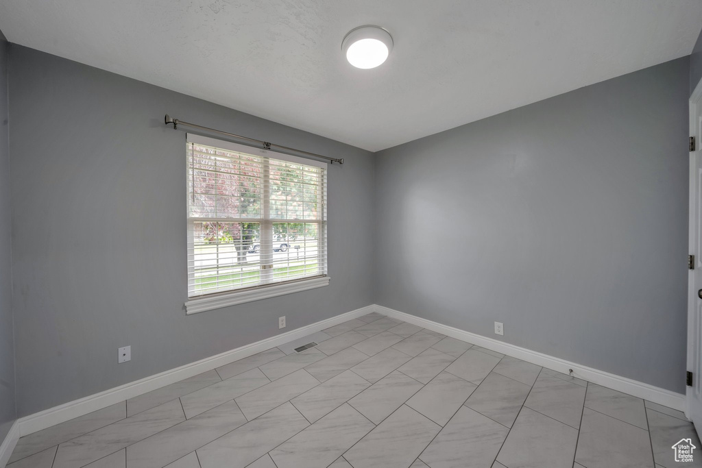 Empty room featuring baseboards
