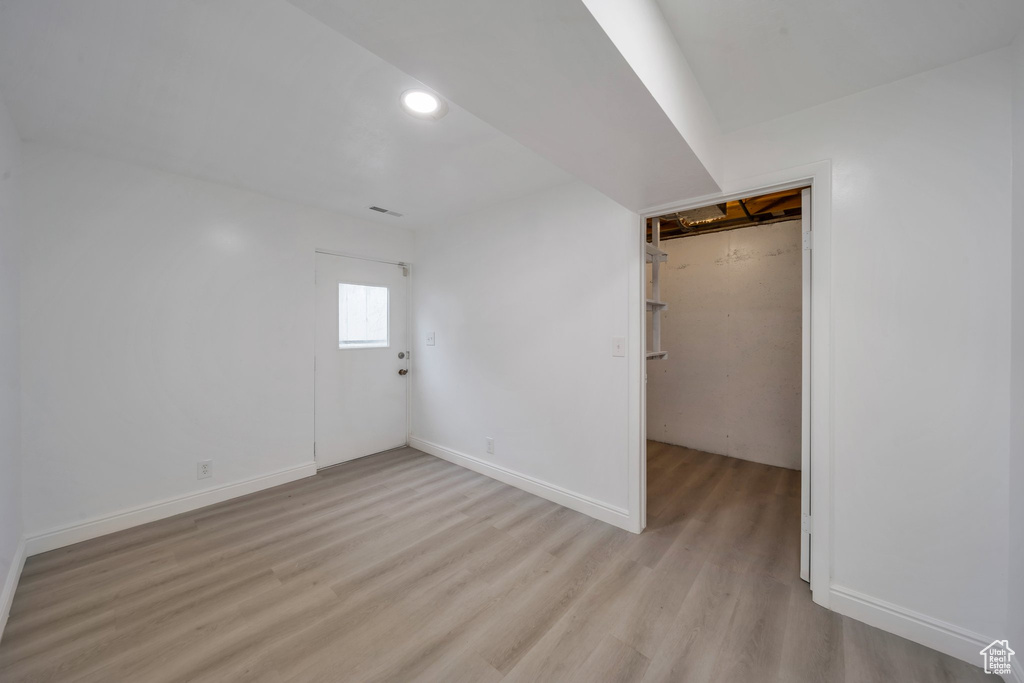 Basement featuring light wood finished floors, recessed lighting, and baseboards