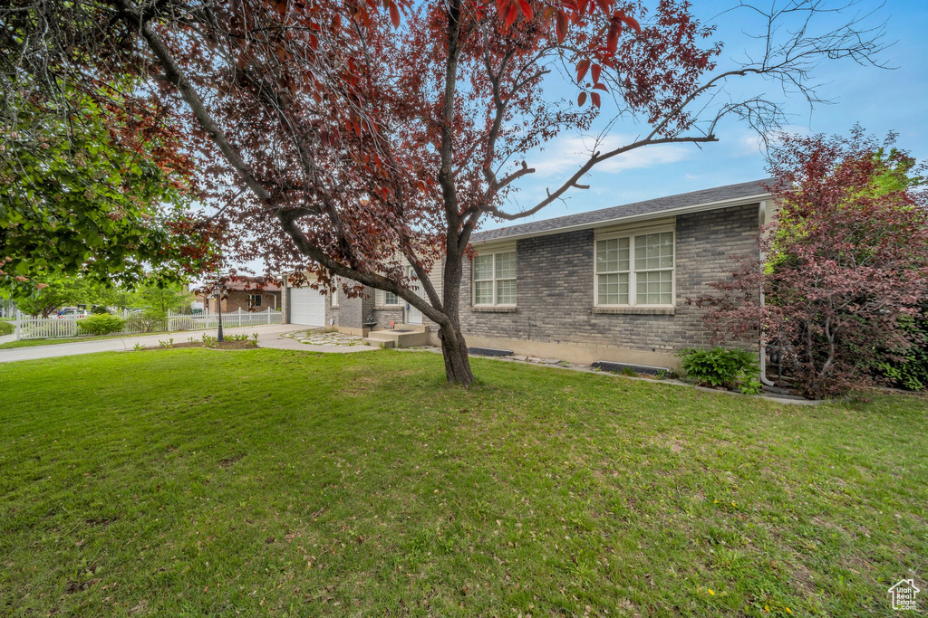 View of yard with driveway and a garage