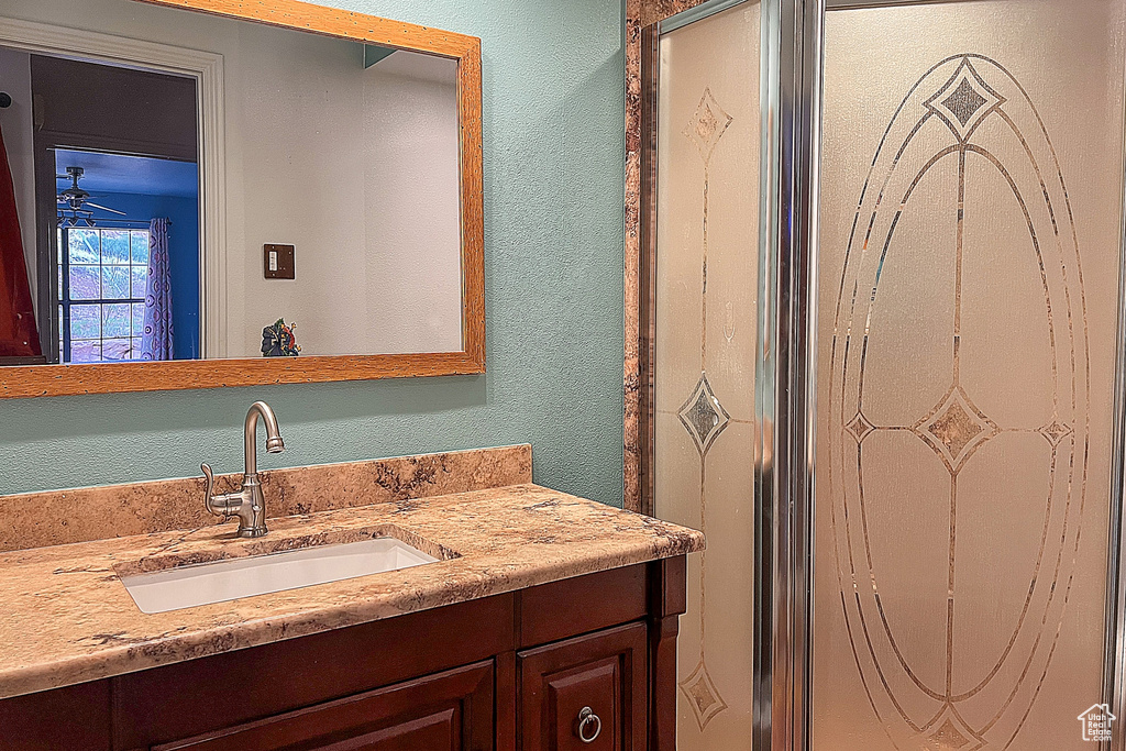 Bathroom with vanity and a textured wall