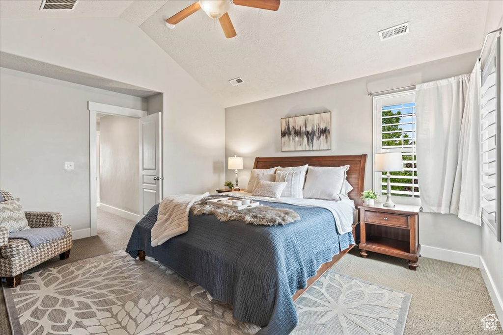 Carpeted bedroom with baseboards, ceiling fan, high vaulted ceiling, and visible vents