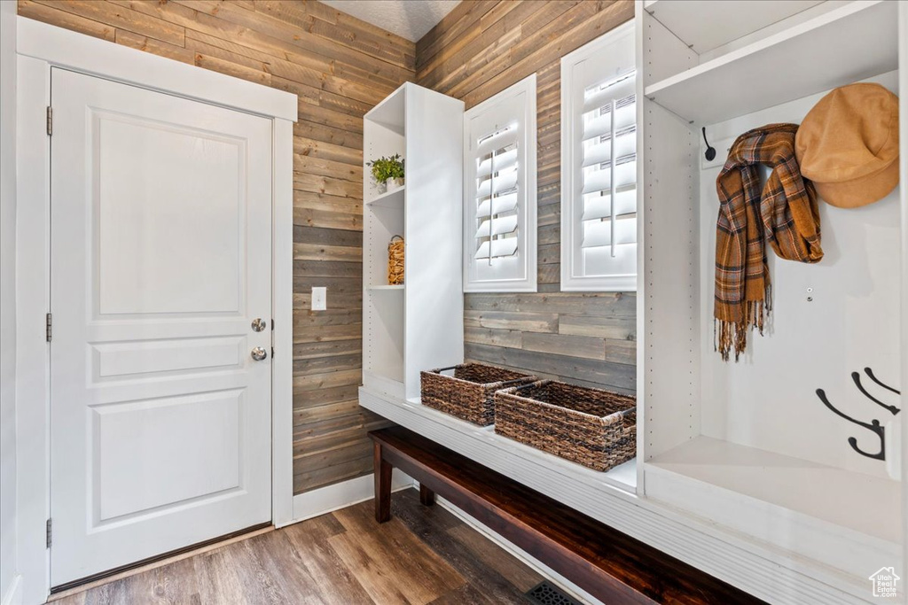 Mudroom featuring wood walls and wood finished floors