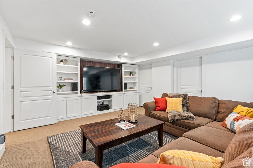 Living room with light colored carpet and recessed lighting