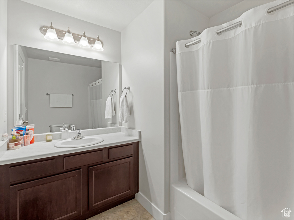 Bathroom featuring shower / bath combo and vanity
